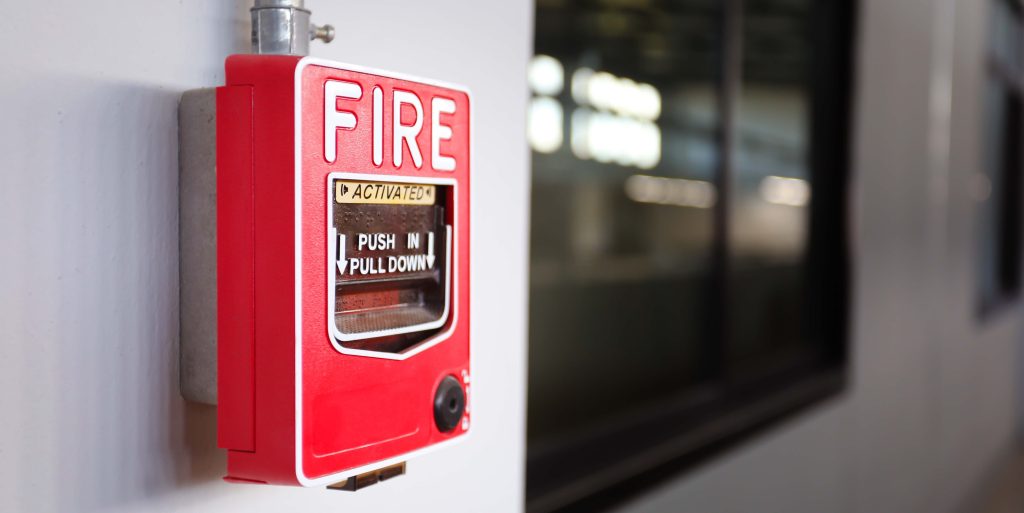 Fire alarm switch on the wall in factory.
