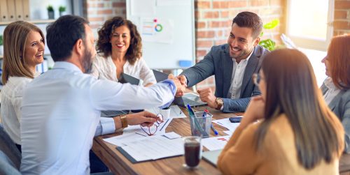 Group of business workers smiling happy and confident. Working together with smile on face shaking hands at the office Group of business workers smiling happy and confident. Working together with smile on face shaking hands at the office