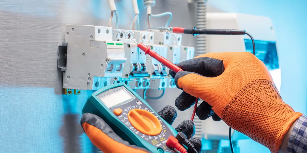 electrician work tester measuring voltage in fuse board. electri