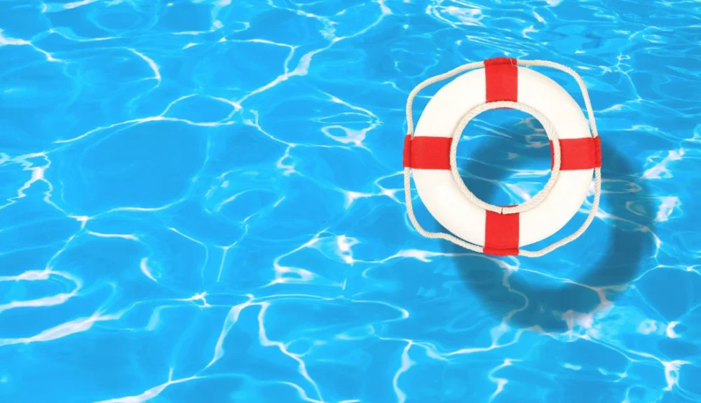 Life preserver floating in clear pool water