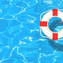 Life preserver floating in clear pool water