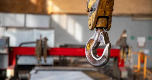 Crane sling hook attached to industrial rigging equipment