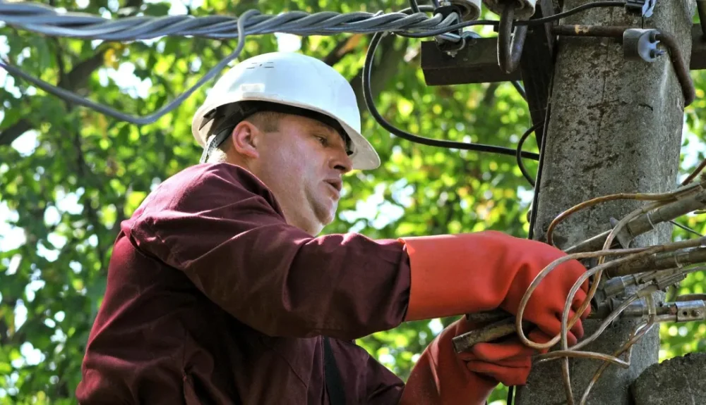 Electrician following electrical safety rules while repairing wires