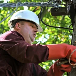 Electrician following electrical safety rules while repairing wires
