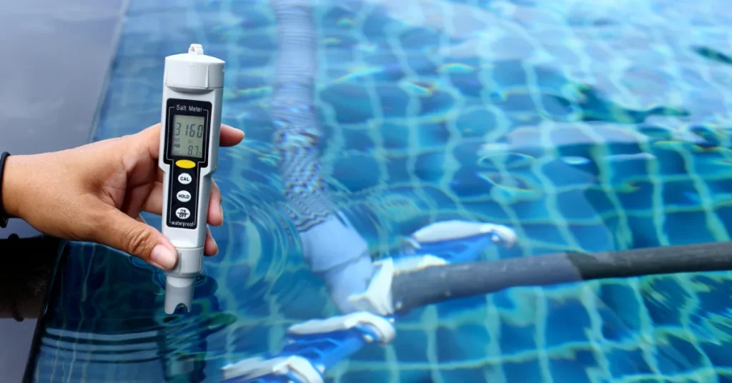 Technician checking salt meter levels during routine pool maintenance Technician checking salt meter levels during routine pool maintenance