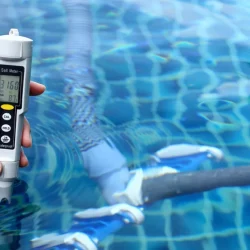 Technician checking salt meter levels during routine pool maintenance