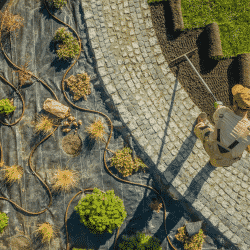 Landscaping business owner laying down lawn turf