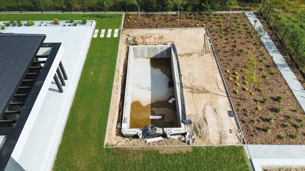 Backyard garden and house with pool construction site