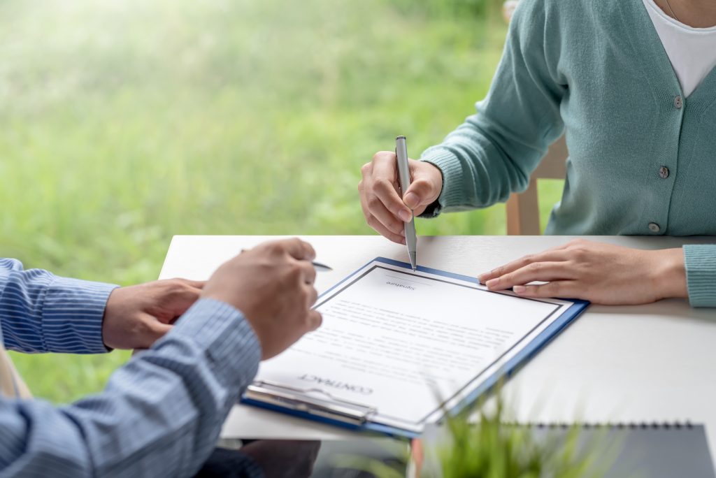 Close-up of business people hands making contract together at th