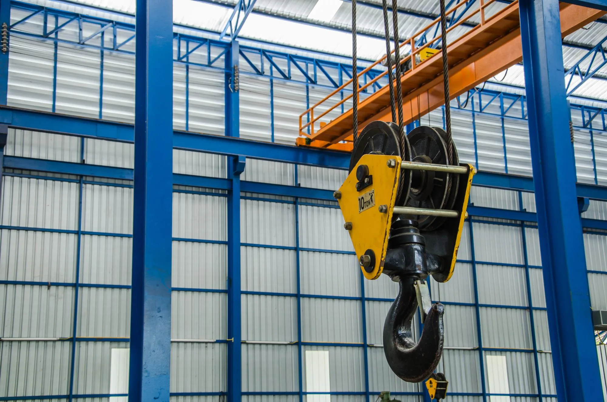Crane sling and hook used for heavy lifting in a factory setting