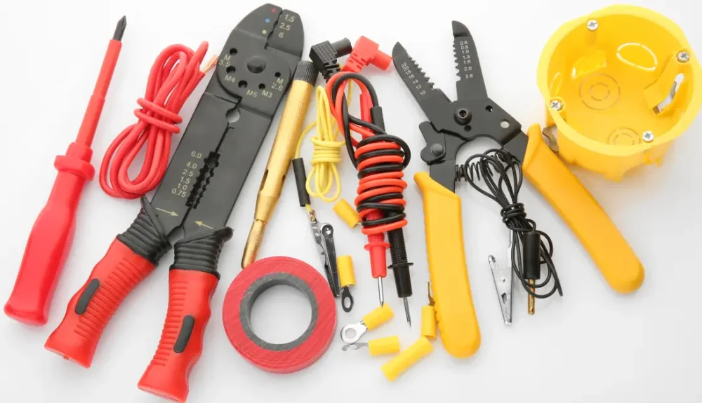 Essential lineman tools including wire strippers, crimpers, and insulated pliers