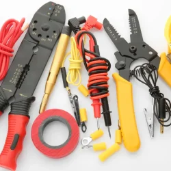 Essential lineman tools including wire strippers, crimpers, and insulated pliers