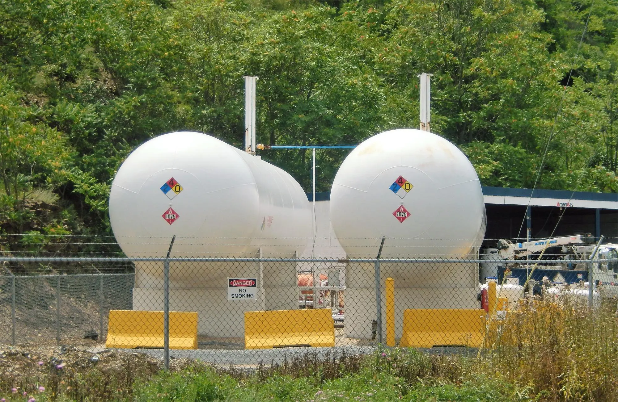 Propane storage tanks with hazard diamonds and fencing