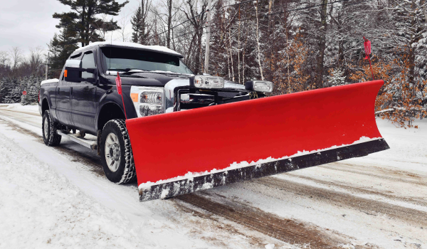 shutterstock_2108109851 Snow plow pickup truck on cleared road