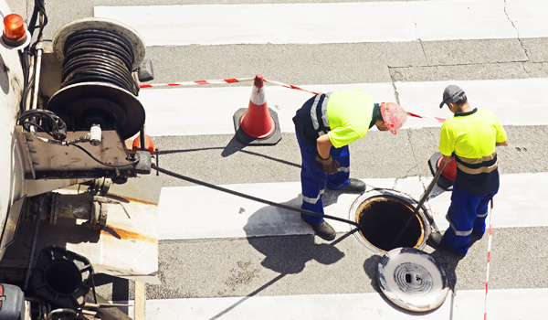 shutterstock_356598134 Utility contractors inspecting sewer system