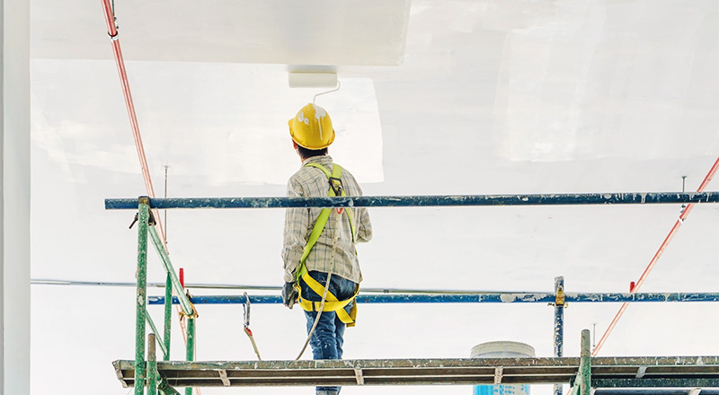 shutterstock_719719597 Interior painting contractor on scaffolding
